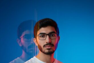 Half-length portrait of a person in an oversized white t-shirt, featuring a dreamlike editorial style with multi-exposure motion blur, vertical streaks, and a deep azure to cyan gradient background. Dramatic lighting uses a cool blue wash with orange/yellow edge glow.